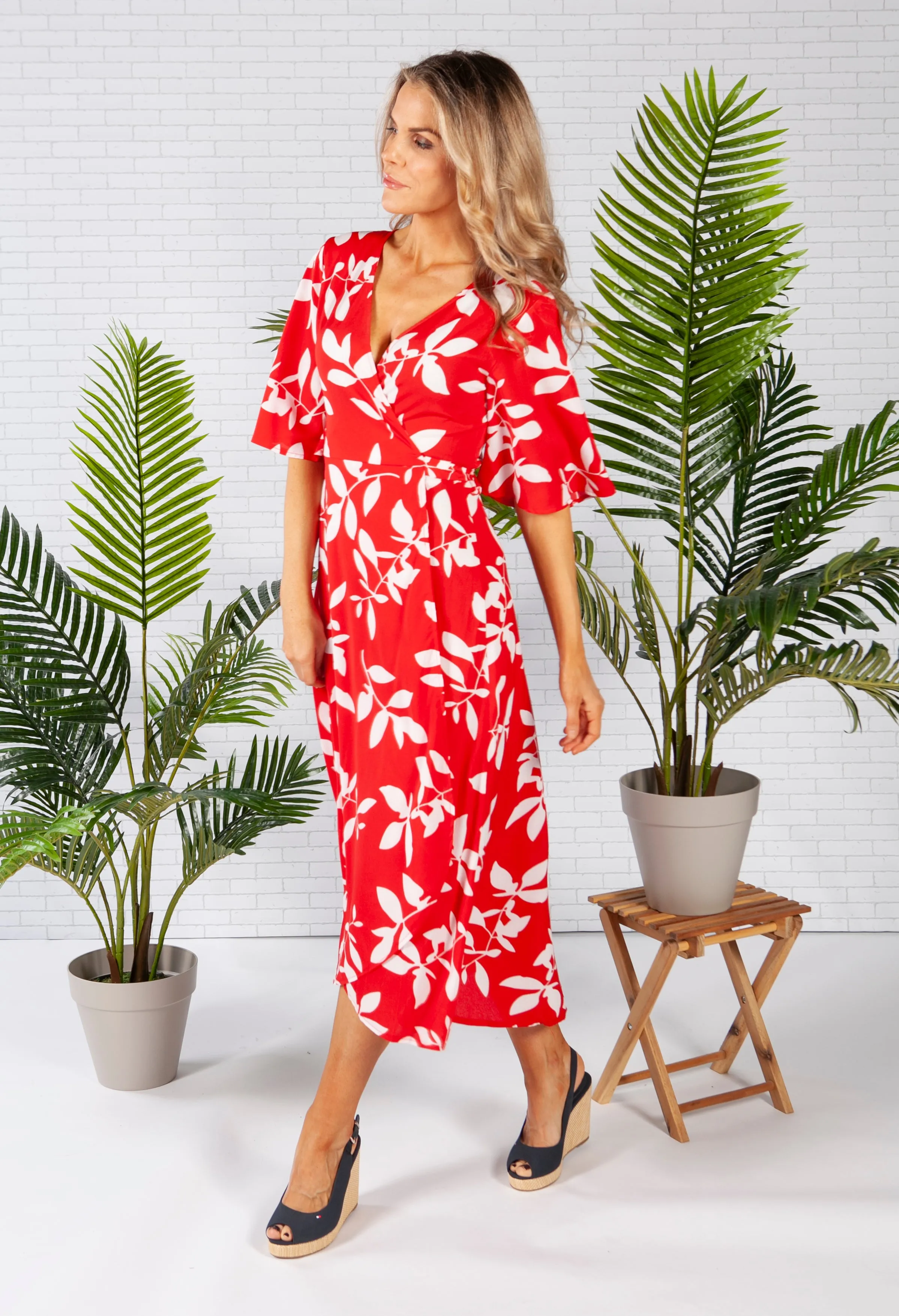 wrap dress in red with a leaf print design