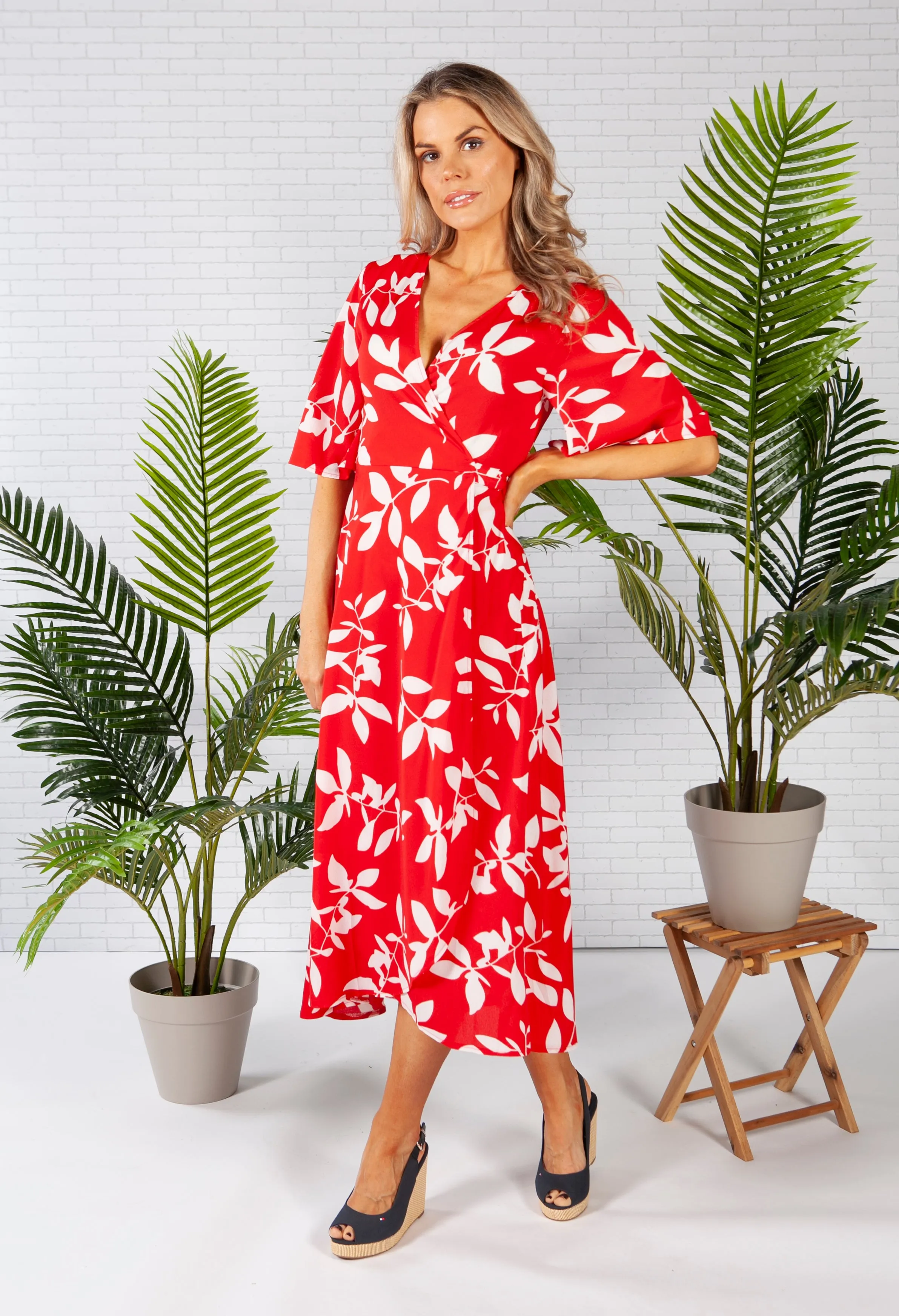 wrap dress in red with a leaf print design